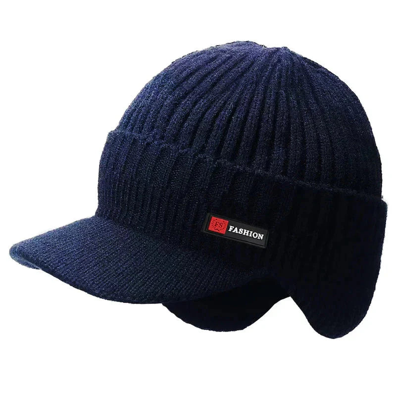 New winter mens hat in dark blue with ear protection and a windproof visor for outdoor activities.